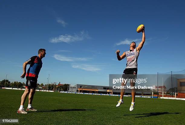 Simon Madden works with Bombers ruckman David Hille during an Essendon Bombers AFL training session at Windy Hill on February 26, 2010 in Melbourne,...