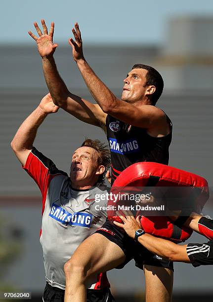 Essendon Development Coach Adrian Hickmott attempts to spoil Scott Gumbleton of the Bombers during an Essendon Bombers AFL training session at Windy...