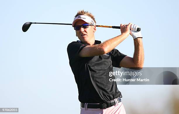 Ian Poulter of England hits his second shot on the 13th hole during the first round of the Waste Management Phoenix Open at TPC Scottsdale on...