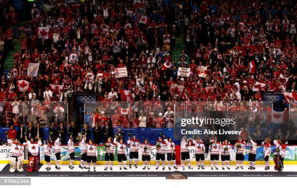 Team Canada wave to the crowd after receiving their gold medals in the medal ceremony following the ice hockey women's gold medal game between Canada...