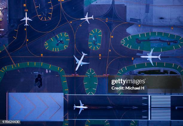 aerial photograph of san francisco international airport in twilight.a moving aircraft. - airport above stock-fotos und bilder