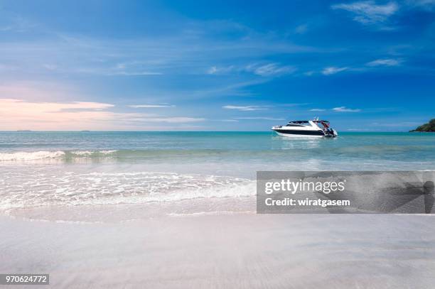 landscape of beautiful coast include in the beach with fishing boat are on the sea, blue sky and green mountain. - wiratgasem stock pictures, royalty-free photos & images