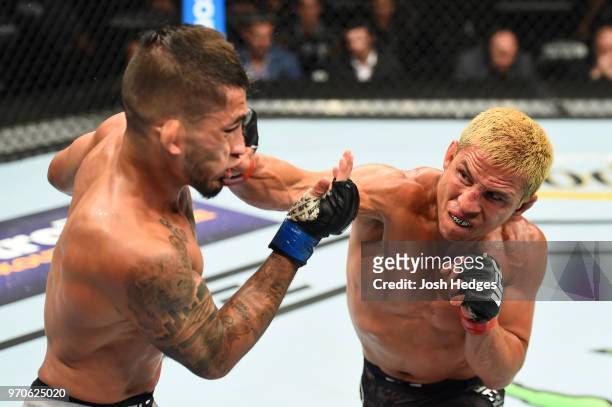 Joseph Benavidez punches Sergio Pettis in their flyweight fight during the UFC 225 event at the United Center on June 9, 2018 in Chicago, Illinois.