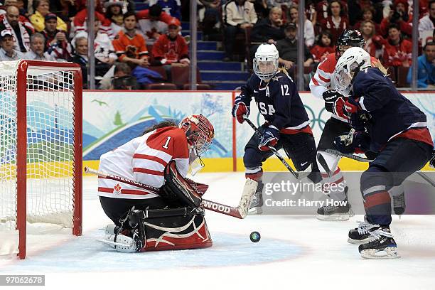 Shannon Szabados of Canada makes a save on a shot by Monique Lamoureux of the United States during the ice hockey women's gold medal game between...