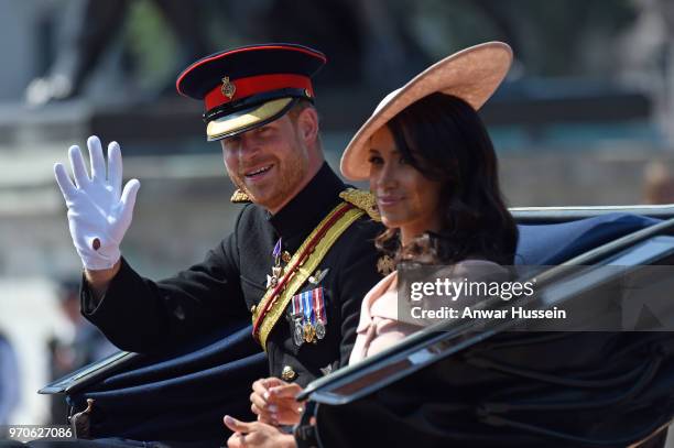 Prince Harry, Duke of Sussex and Meghan, Duchess of Sussex travel in an open carriage to the Trooping the Colour ceremony on June 09, 2018 in London,...