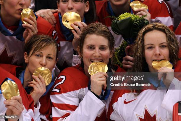 Team captain Hayley Wickenheiser of Canada poses alongside teammates with the gold medals received following their team's 2-0 victory during the ice...