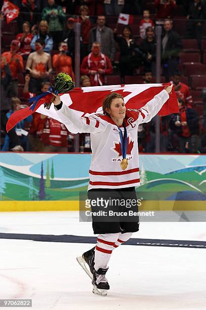 Team captain Hayley Wickenheiser of Canada celebrates with her national flag after receiving the gold medal following her team's 2-0 victory during...