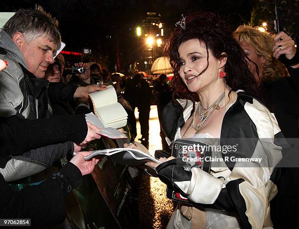 Actress Helena Bonham Carter signs autographs for fans on arrival at the Royal World Premiere of 'Alice In Wonderland' at Odeon Leicester Square on...