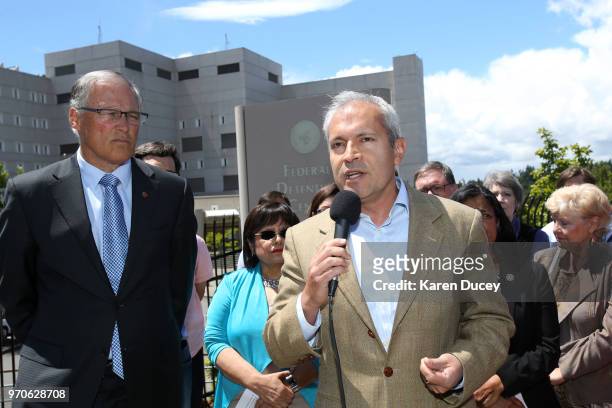 Jorge Baron, executive director of the Northest Immigration Rights Project speaks at a press conference outside the Federal Detention Center holding...