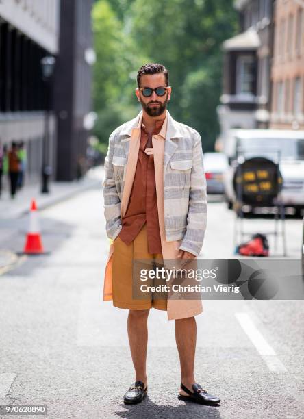 Guest wearing shorts is seen during London Fashion Week Men's June 2018 on June 9, 2018 in London, England.