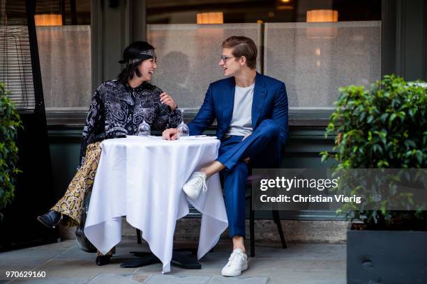 Betty Bachz wearing suit with leopard print and Toby Huntington-Whiteley sitting in a restaurant is seen during London Fashion Week Men's June 2018...