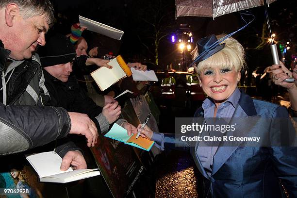 Actress Barbara Windsor signs autographs for fans on arrival at the Royal World Premiere of 'Alice In Wonderland' at Odeon Leicester Square on...