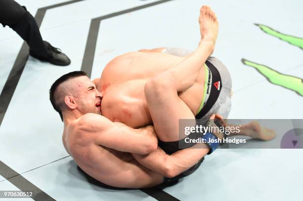 Ricardo Lamas attempts a submission against Mirsad Bektic of Bosnia in their featherweight fight during the UFC 225 event at the United Center on...