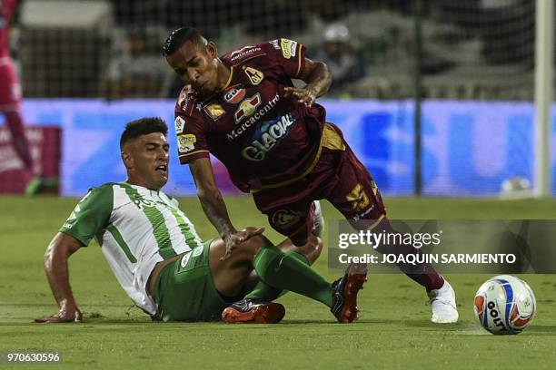 Atletico Nacional player Diego Braghieri vies for the ball with Deportes Tolima player Sebastian Villa during their Colombian League final game at...