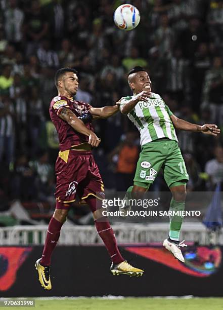 Atletico Nacional player Vladimir Hernandez vies for the ball with Deportes Tolima player Juan Guillermo Arboleda during their Colombian League final...