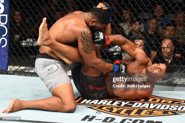 Alistair Overeem punches Curtis Blaydes in their heavyweight fight during the UFC 225 event at the United Center on June 9, 2018 in Chicago, Illinois.