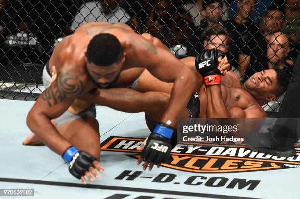 Alistair Overeem attempts a heel hook against Curtis Blaydes in their heavyweight fight during the UFC 225 event at the United Center on June 9, 2018...