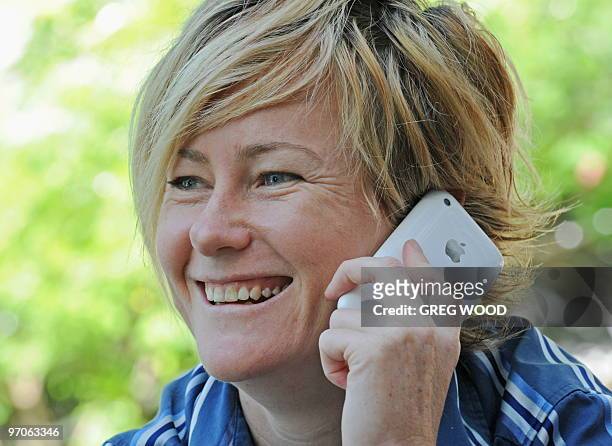 Australia-technology-Internet-networking,FEATURE by Amy Coopes Danielle Warby speaks on her smartphone in Sydney on February 25, 2010. Warby is one...