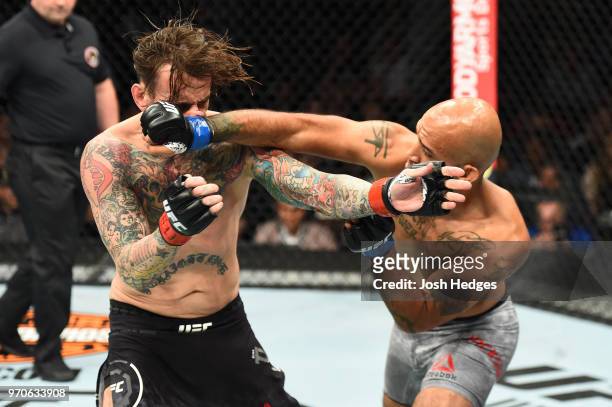 Mike Jackson punches CM Punk in their welterweight fight during the UFC 225 event at the United Center on June 9, 2018 in Chicago, Illinois.