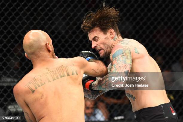 Mike Jackson punches CM Punk in their welterweight fight during the UFC 225 event at the United Center on June 9, 2018 in Chicago, Illinois.