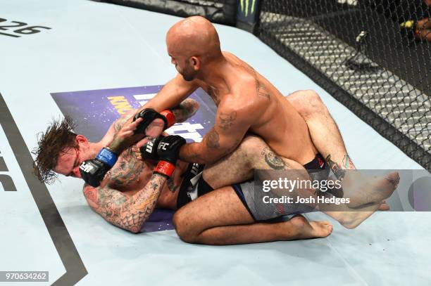 Mike Jackson punches CM Punk in their welterweight fight during the UFC 225 event at the United Center on June 9, 2018 in Chicago, Illinois.