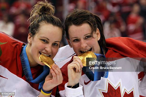 Marie-Philip Poulin and Catherine Ward of Canada celebrate with the gold medals won during the ice hockey women's gold medal game between Canada and...