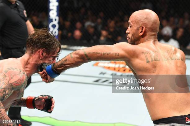 Mike Jackson punches CM Punk in their welterweight fight during the UFC 225 event at the United Center on June 9, 2018 in Chicago, Illinois.