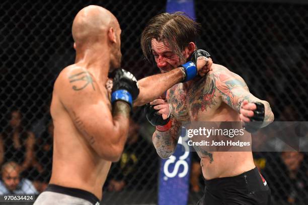 Mike Jackson punches CM Punk in their welterweight fight during the UFC 225 event at the United Center on June 9, 2018 in Chicago, Illinois.