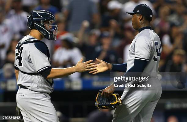 Catcher Gary Sanchez and closer Aroldis Chapman of the New York Yankees shake hands after defeating the New York Mets 4-3 in a game at Citi Field on...