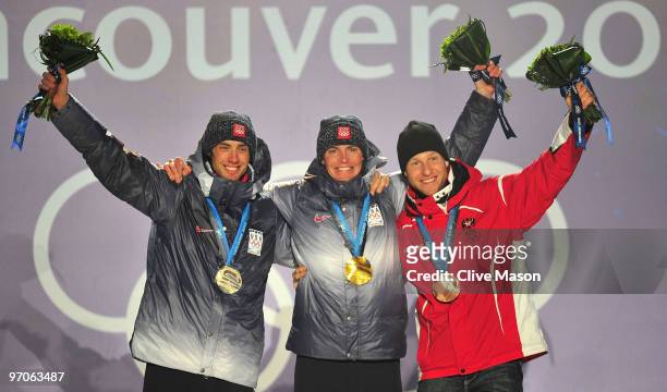 Johnny Spillane of the United States receives the silver medal, Bill Demong of the United States receives the gold medal and Bernhard Gruber of...