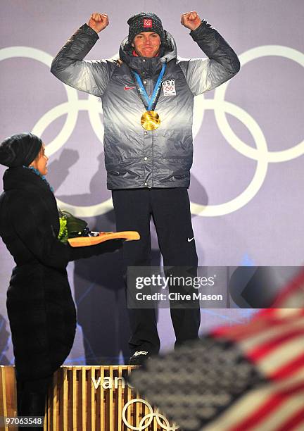 Bill Demong of the United States receives the gold medal during the medal ceremony for the men's individual large hill 10 km Nordic combined held at...