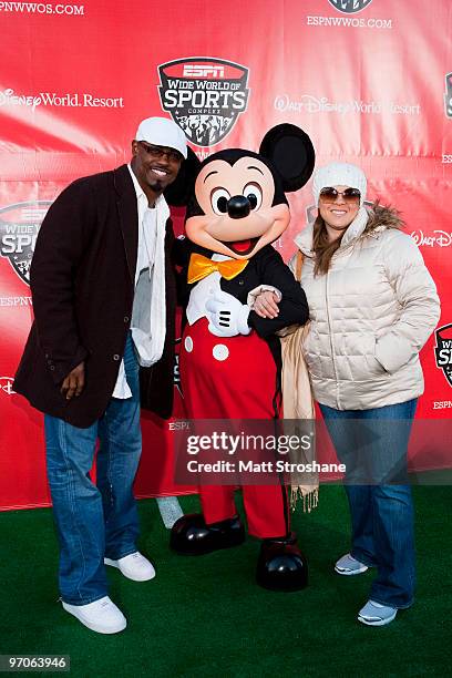 Brian Dawkins, of the Denver Broncos and wife Connie Dawkins walk the red carpet with Mickey Mouse at the official relaunch of the ESPN Wide World of...