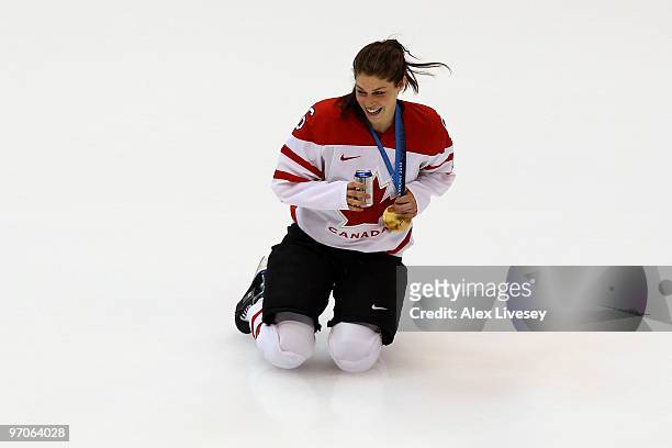 Rebecca Johnston of Canada celebrates winning the gold medal with a beer following her team's 2-0 victory during the ice hockey women's gold medal...