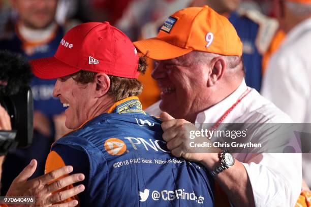 Scott Dixon, driver of the PNC Bank Chip Ganassi Racing Honda, and team owner Chip Ganassi celebrate in Victory Lane after winning the Verizon...