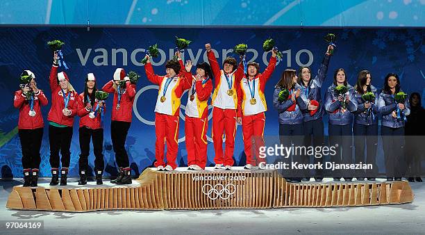 Team Canada receives the silver medal, Team China receives the gold medal and Team USA receives the bronze medal during the medal ceremony for the...