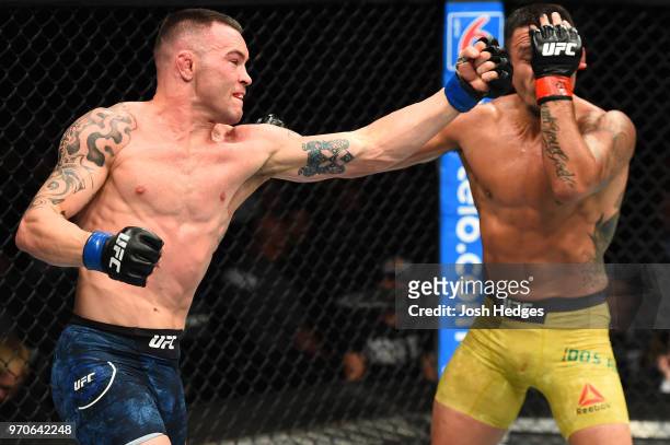 Colby Covington punches Rafael Dos Anjos of Brazil in their interim welterweight title fight during the UFC 225 event at the United Center on June 9,...