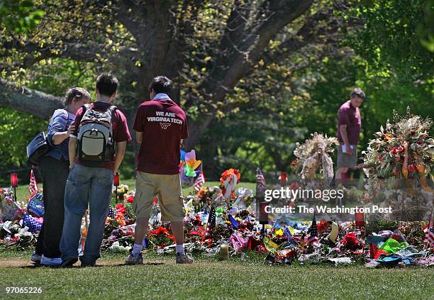 VTGrads Photos by Michael Williamson NEG#190519 5/8/07: A woman comforts two Asian Virginia Tech students at the memorial for the slain in front of...