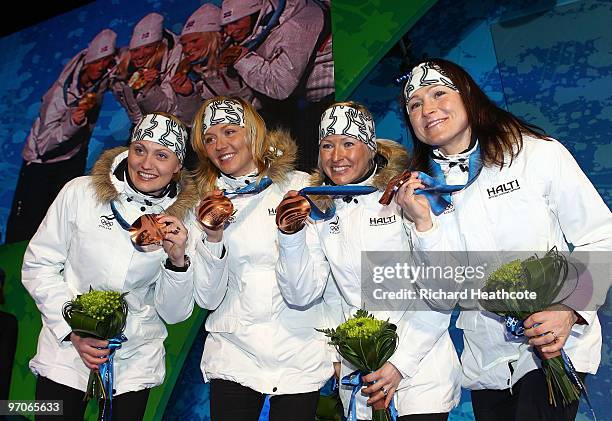 Team Finland celebrates receiving the bronze medal during the medal ceremony for the ladies' 4x5 km cross-country skiing relay on day 14 of the...