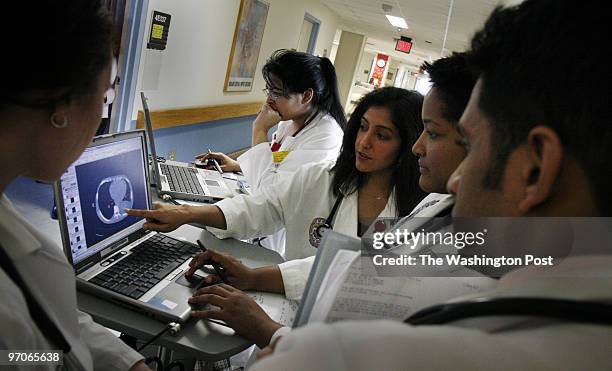 The use of electronic medical records at the VA hospital. Washington VA medical Center 50 Irving Street NW. Doctors discuss a patient's records using...