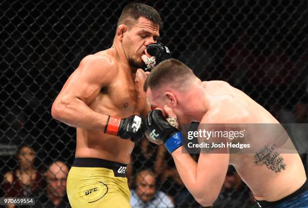 Colby Covington punches Rafael Dos Anjos of Brazil in their interim welterweight title fight during the UFC 225 event at the United Center on June 9,...