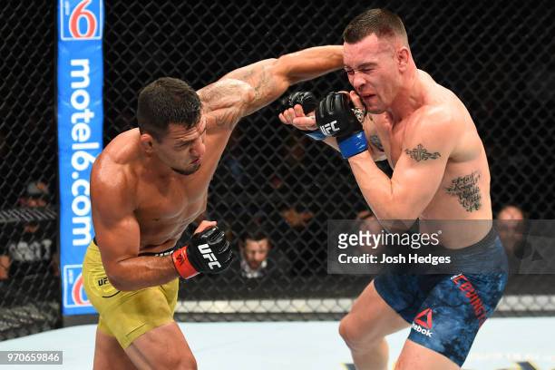 Rafael Dos Anjos of Brazil punches Colby Covington in their interim welterweight title fight during the UFC 225 event at the United Center on June 9,...