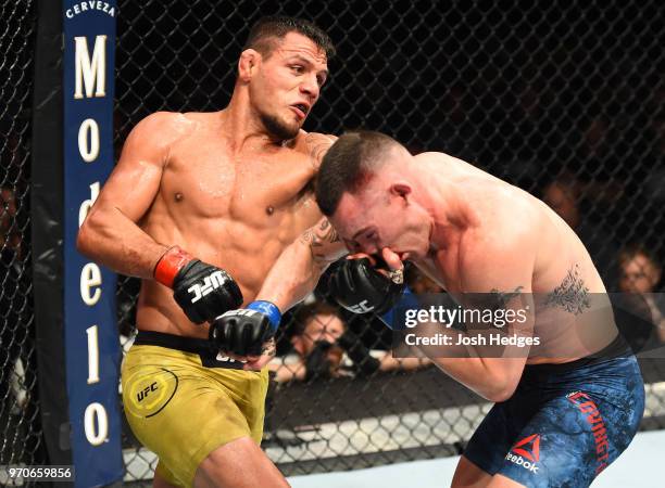 Rafael Dos Anjos of Brazil punches Colby Covington in their interim welterweight title fight during the UFC 225 event at the United Center on June 9,...