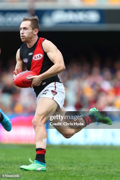 Devon Smith of the Bombers runs the ball during the round 12 AFL match between the Brisbane Lions and the Essendon Bombers at The Gabba on June 10,...