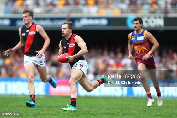 Devon Smith of the Bombers runs the ball during the round 12 AFL match between the Brisbane Lions and the Essendon Bombers at The Gabba on June 10,...