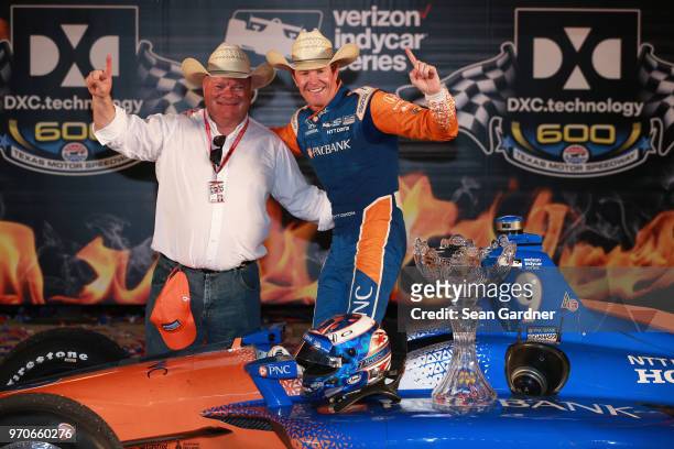 Scott Dixon, driver of the PNC Bank Chip Ganassi Racing Honda, and team owner Chip Ganassi celebrate in Victory Lane after winning the Verizon...