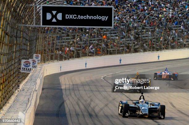 Ed Carpenter, driver of the Ed Carpenter Racing Fuzzy's Vodka Chevrolet, leads a pack of cars during the Verizon IndyCar Series DXC Technology 600 at...