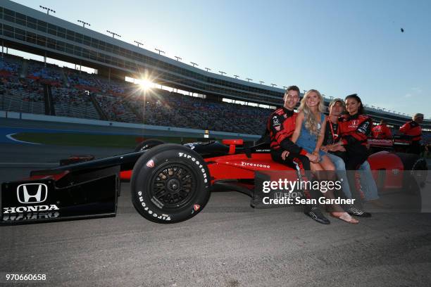 Cody Nickson and Jessica Graf pose for a photo with Arie Luyendyk Jr. And Lauren Burnham prior to the Verizon IndyCar Series DXC Technology 600 at...