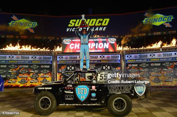 Gavin Harlien, driver of the United Fiber & Data truck poses for a photo in victory lane after winning the Speed Energy Stadium Super Trucks Series...