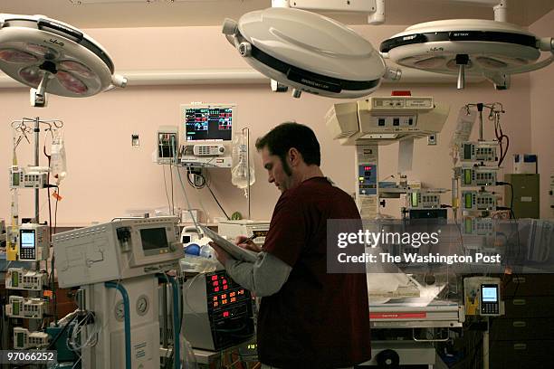 Georgetown University Hospital Neonatal Intensive Care Unit Respiratory therapist Gary S. Hall monitors a baby hooked up to a 'Jet' High Frequency...