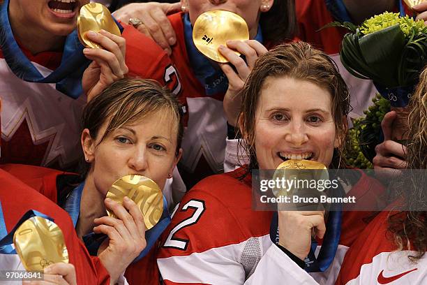 Jayna Hefford and Captain Hayley Wickenheiser of Canada celebrate after receiving the gold medal following their team's 2-0 victory during the ice...